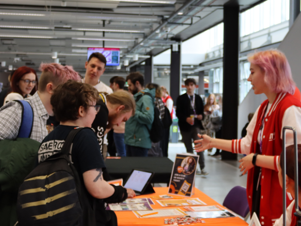 Photograph of students signing up for new societies at Freshers Week.