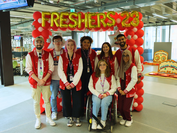 Photo of the SA team under a Freshers Balloon sign