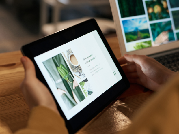 Picture of a woman browsing the internet on a tablet.